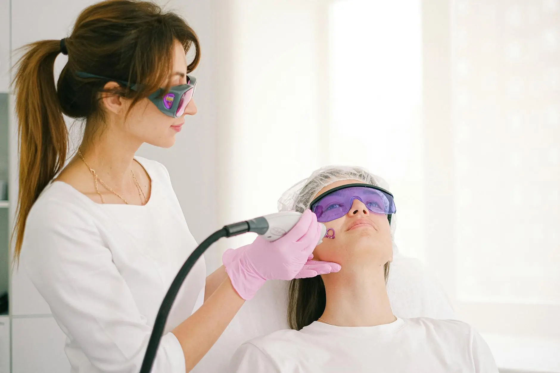 cosmetologist performing scar whitening on a woman