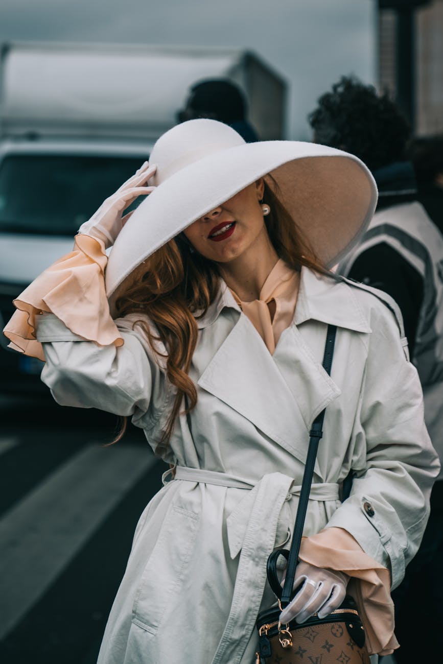 elegant woman in white hat at paris fashion week